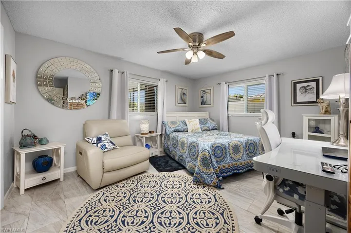 Bedroom featuring a textured ceiling and ceiling fan