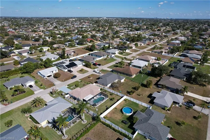 Aerial view of property's location featuring nearby suburban area