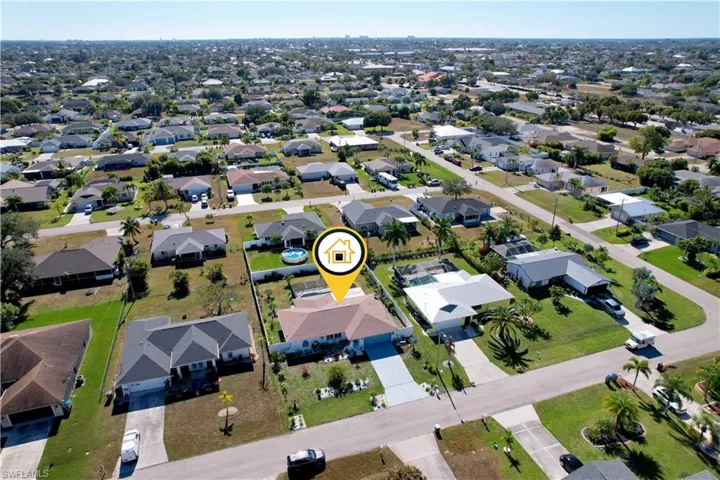 Aerial view of property's location featuring nearby suburban area
