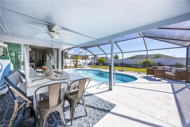 View of pool with an outdoor hangout area, a sunroom, a lanai, a patio, and a fenced backyard