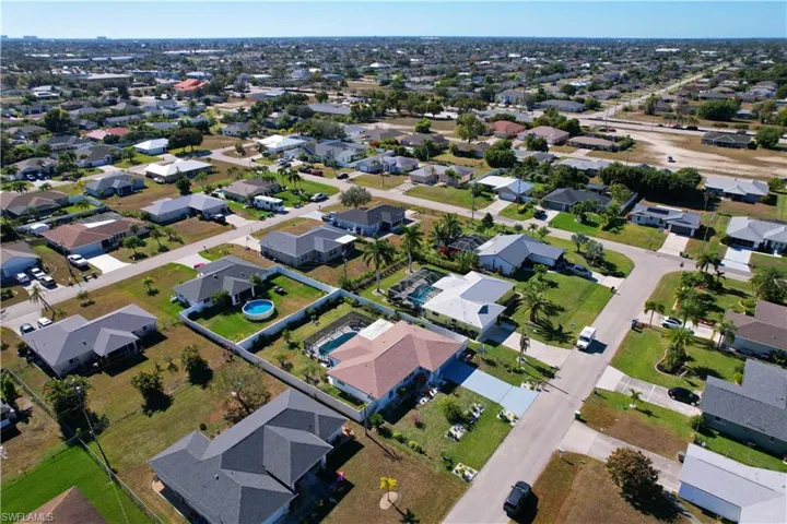 Aerial view of property's location featuring nearby suburban area