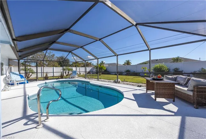 View of pool featuring a lanai, a sunroom, a patio, outdoor lounge area, and a fenced backyard