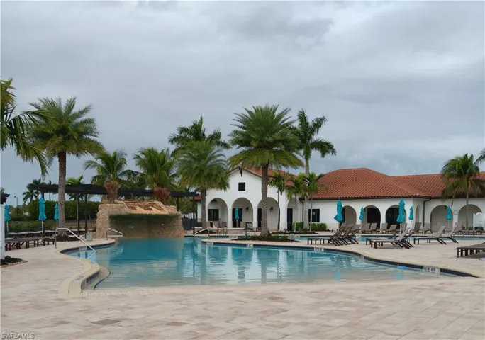 Beautiful pool with waterfall & chaise lounge seating