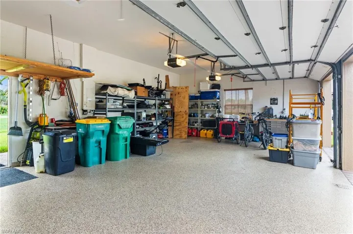 Garage featuring a workshop area and a garage door opener
