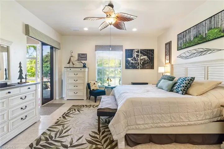 Bedroom with ceiling fan, access to exterior, and light tile floors