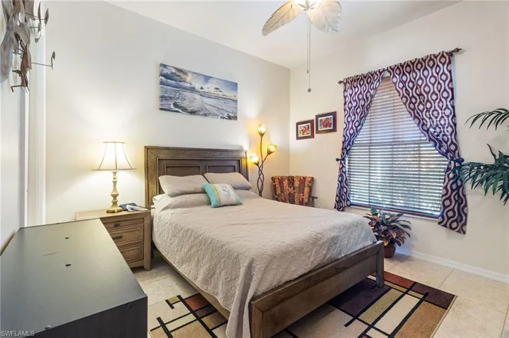 Bedroom with tile floors and ceiling fan