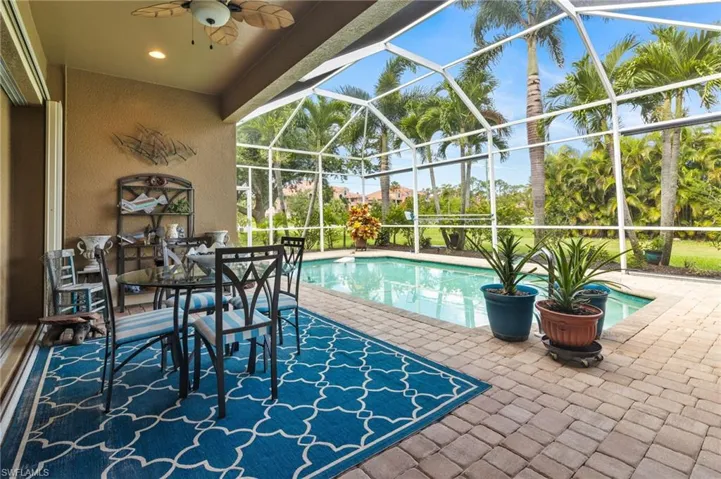View of swimming pool featuring ceiling fan, a lanai, and a patio