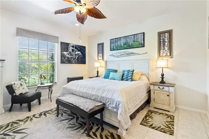 Bedroom featuring ceiling fan and light tile floors