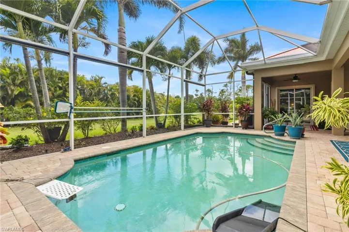 View of pool featuring a lanai, a patio area, and ceiling fan