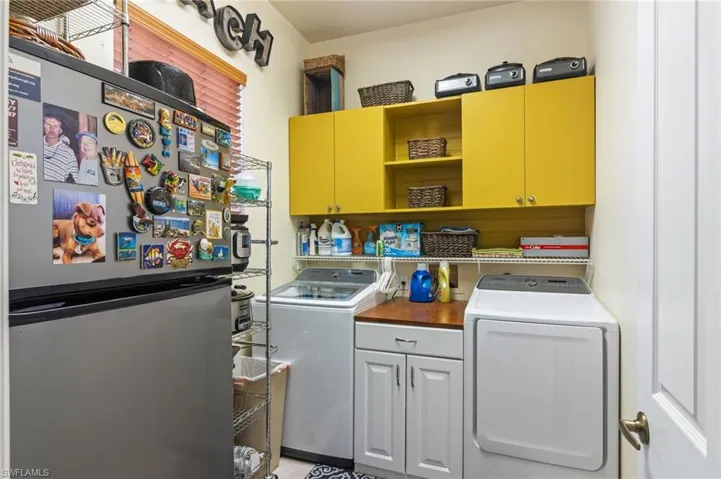 Laundry area featuring cabinets and independent washer and dryer