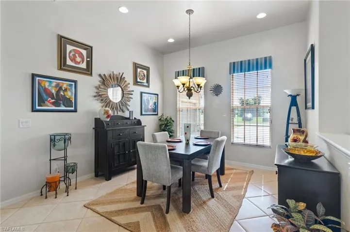 Dining area featuring light tile flooring and a chandelier