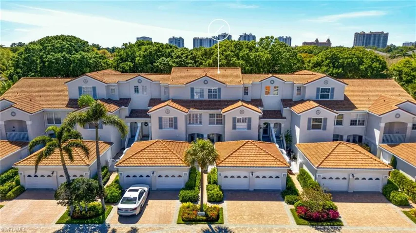 The property features a Mediterranean-style exterior with a terracotta tile roof, white stucco walls, and decorative shutters
