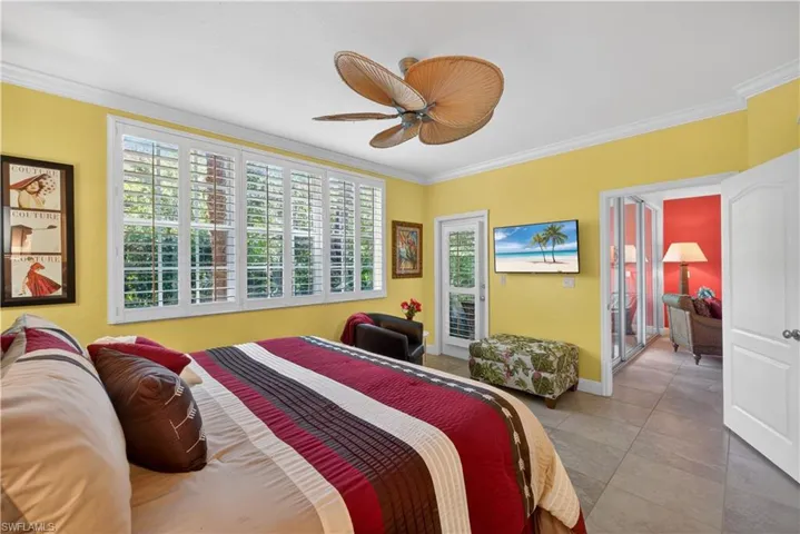 The property features tile flooring, crown molding, and a ceiling fan