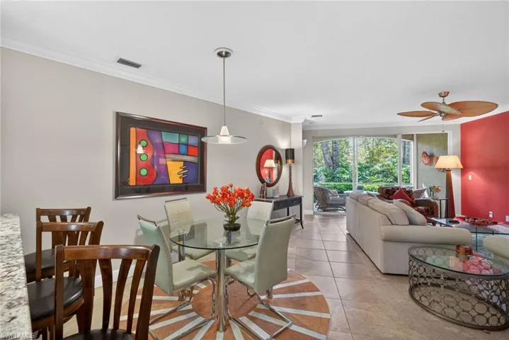 The property features an open-concept living area with tile flooring, a dining space with a pendant light fixture, and a living room with a ceiling fan
