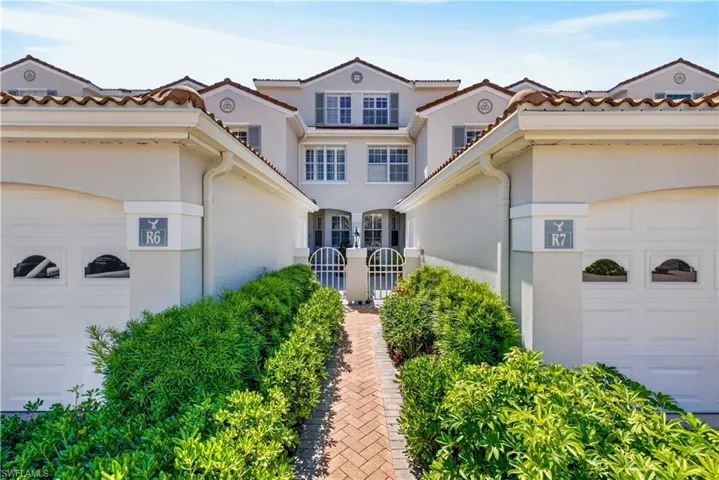 The property features a stucco exterior with a tile roof and decorative window shutters