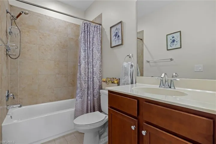 Full bathroom with shower / tub combo, vanity, and toilet