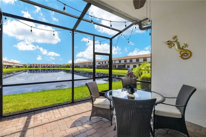 Sunroom / solarium featuring a water view