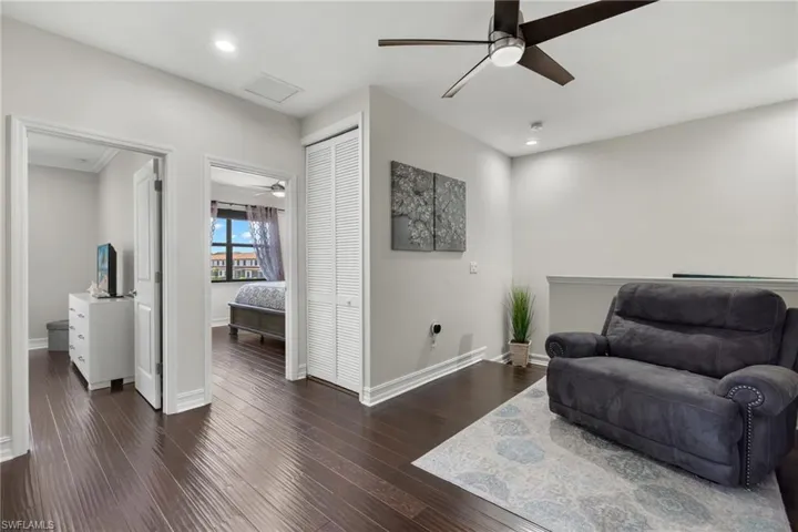 Sitting room featuring ceiling fan and dark hardwood / wood-style flooring