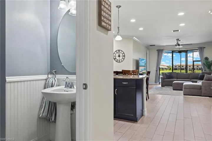Bathroom featuring ceiling fan, hardwood / wood-style flooring, and ornamental molding
