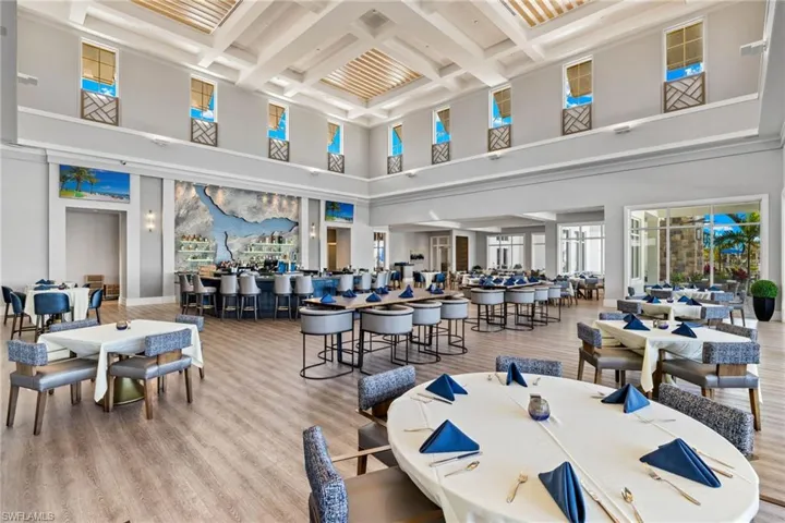 Dining area with light wood finished floors and coffered ceiling