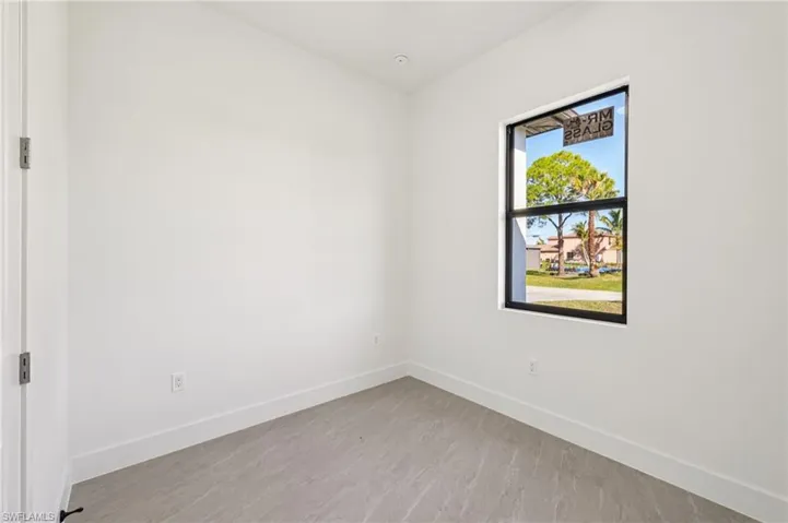 Unfurnished room with baseboards
