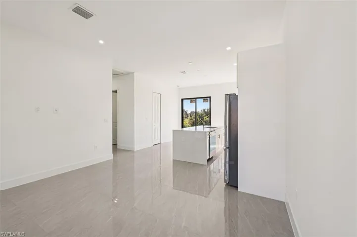Empty room featuring recessed lighting and baseboards