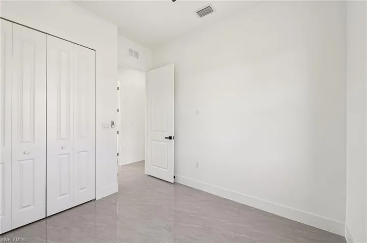 Unfurnished bedroom with a closet and baseboards