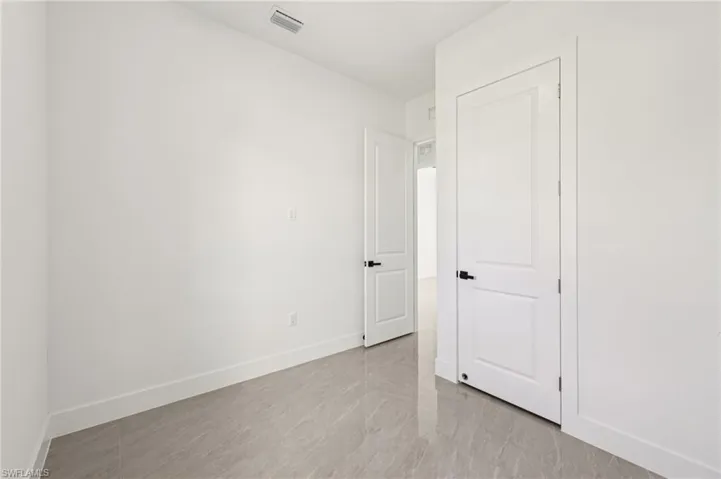 Unfurnished bedroom featuring light tile patterned flooring