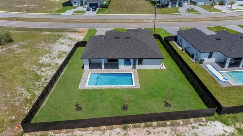 Aerial view of residential area featuring a pool area