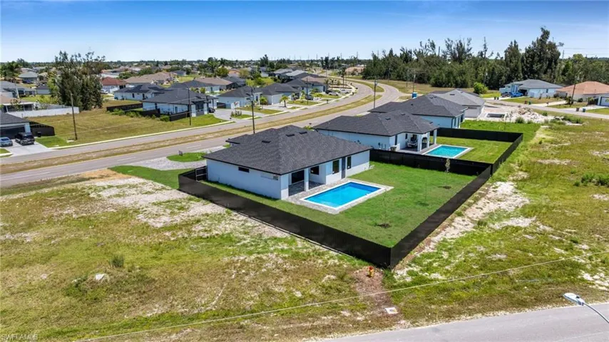 Aerial perspective of suburban area with a pool