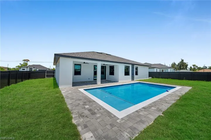 Back of house featuring a ceiling fan, stucco siding, a patio area, and roof with shingles