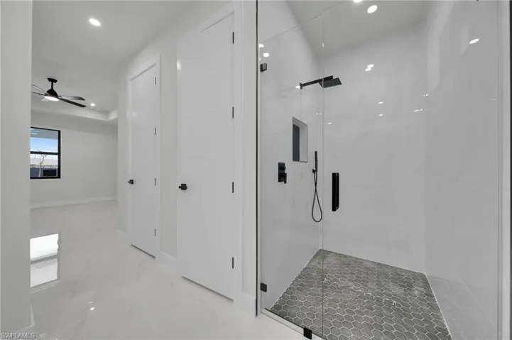 Bathroom featuring recessed lighting, marble tiled flooring, a marble finish shower, and ceiling fan