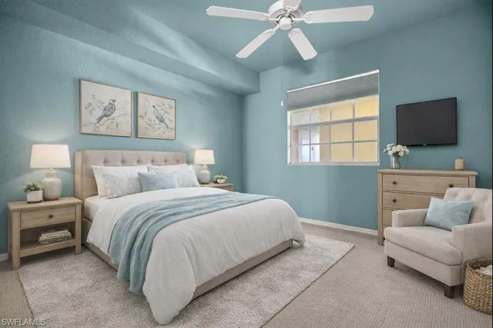 Bedroom featuring ceiling fan and carpet