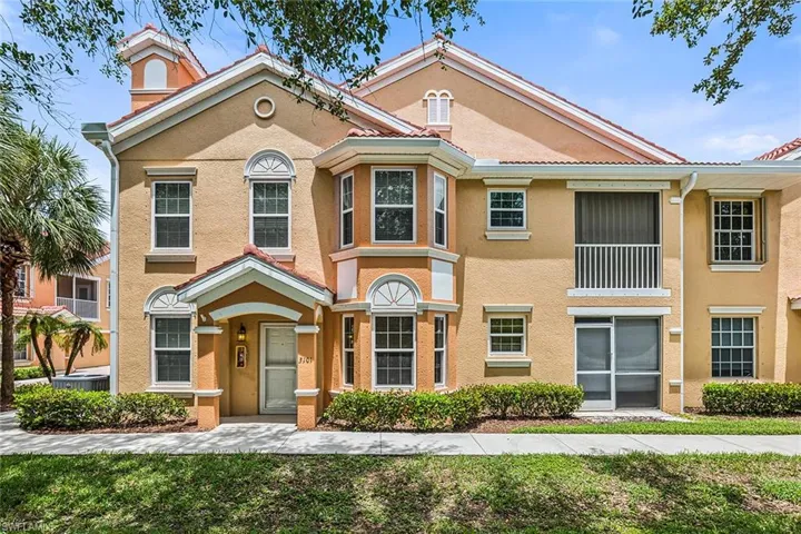 Townhome / multi-family property with stucco siding and a chimney