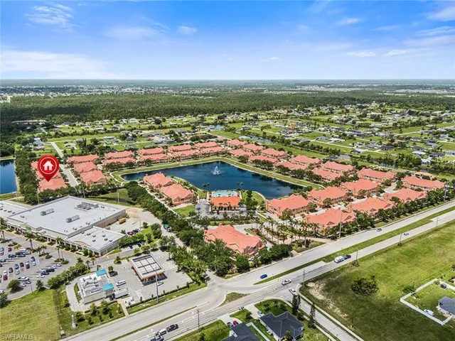 Aerial view of residential area featuring a nearby body of water