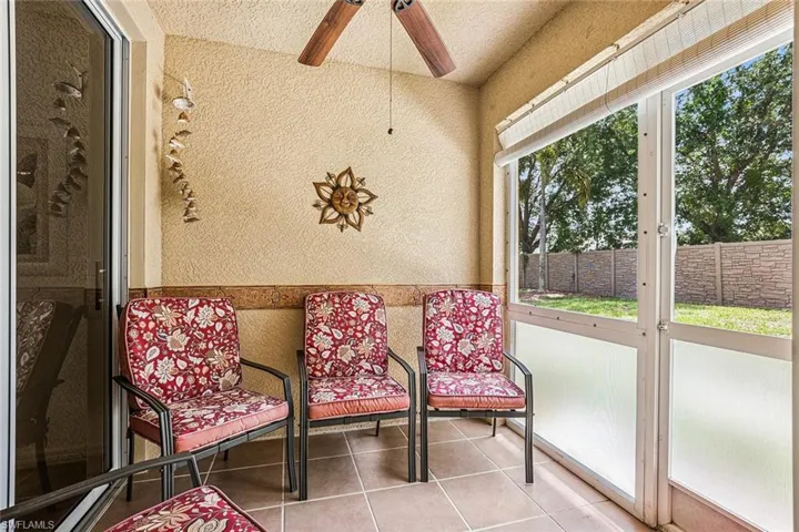 Sunroom featuring healthy amount of natural light and a ceiling fan