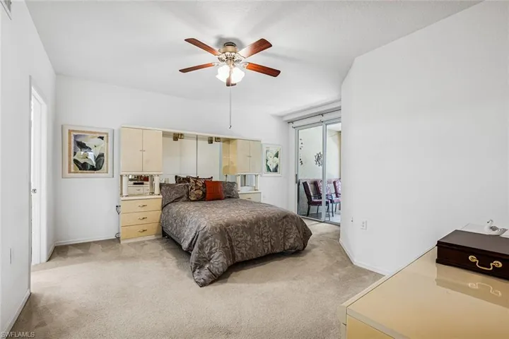 Bedroom featuring light carpet and ceiling fan