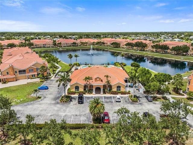 Aerial view of residential area featuring a nearby body of water