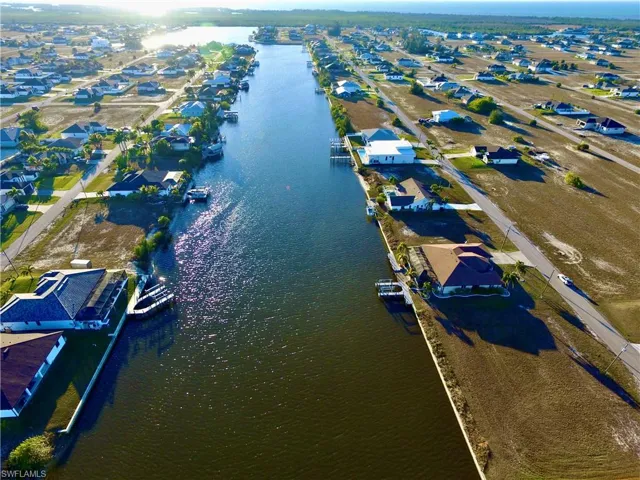 View of property location featuring a large body of water and nearby suburban area