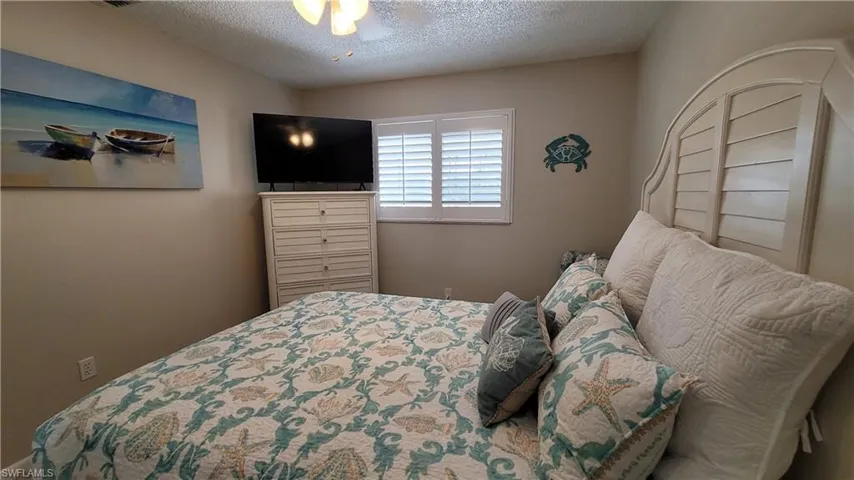 Bedroom with a textured ceiling