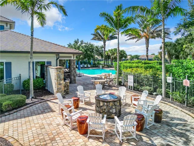 View of patio featuring an outdoor fire pit and a community pool
