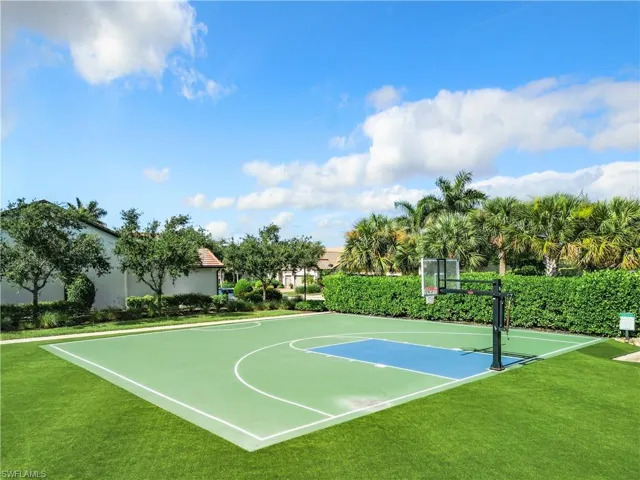 View of sport court featuring a lawn