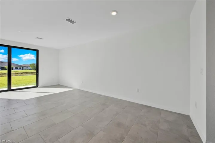 Spare room featuring baseboards