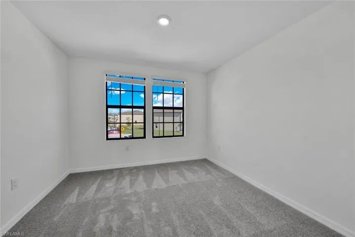 Spare room with carpet floors and baseboards