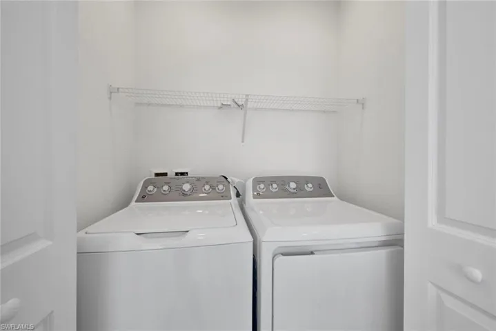 Washroom featuring washing machine and clothes dryer