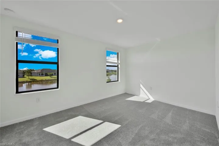 Unfurnished room featuring carpet, baseboards, and recessed lighting