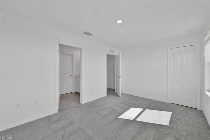 Unfurnished bedroom with carpet floors, baseboards, and recessed lighting