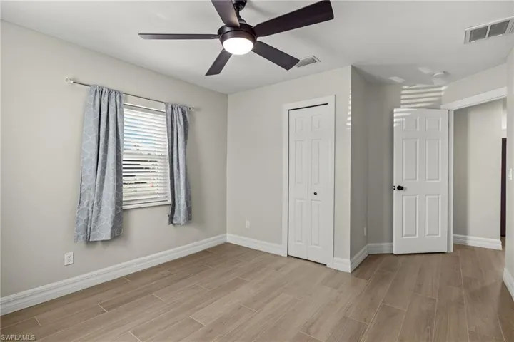 Unfurnished bedroom featuring ceiling fan, light wood-type flooring, and a closet