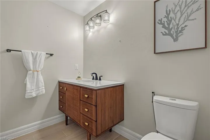 Bathroom featuring hardwood / wood-style floors, vanity, and toilet