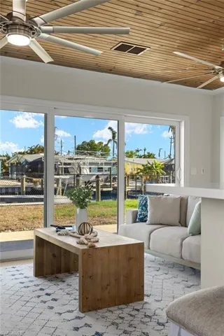 Sunroom featuring ceiling fan, wood ceiling, and a wealth of natural light